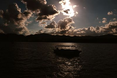 Boats in sea at sunset