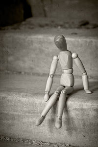 Close-up of wooden figurine on steps