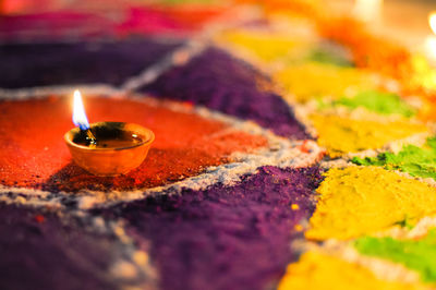 Close-up of diya on rangoli