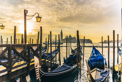 View of wooden post in venice at sunrise
