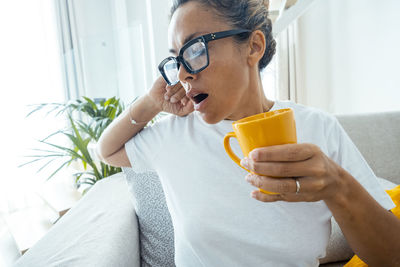 Midsection of woman drinking glass