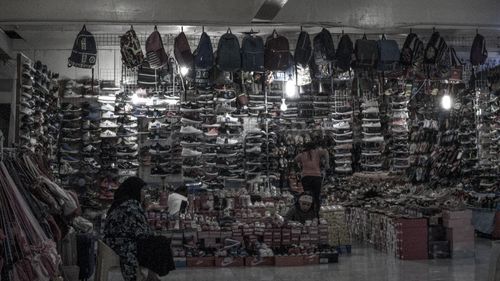 Man hanging in store for sale at market