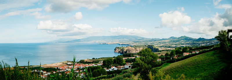 High angle view of townscape by sea against sky