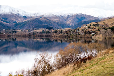 Scenic view of lake and mountains against sky