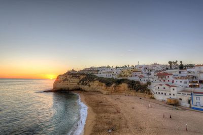 Scenic view of sea against clear sky during sunset