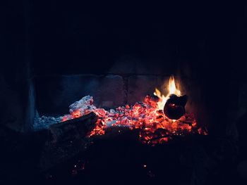 Picture of a wood fire made at night,, there is low light, coal,