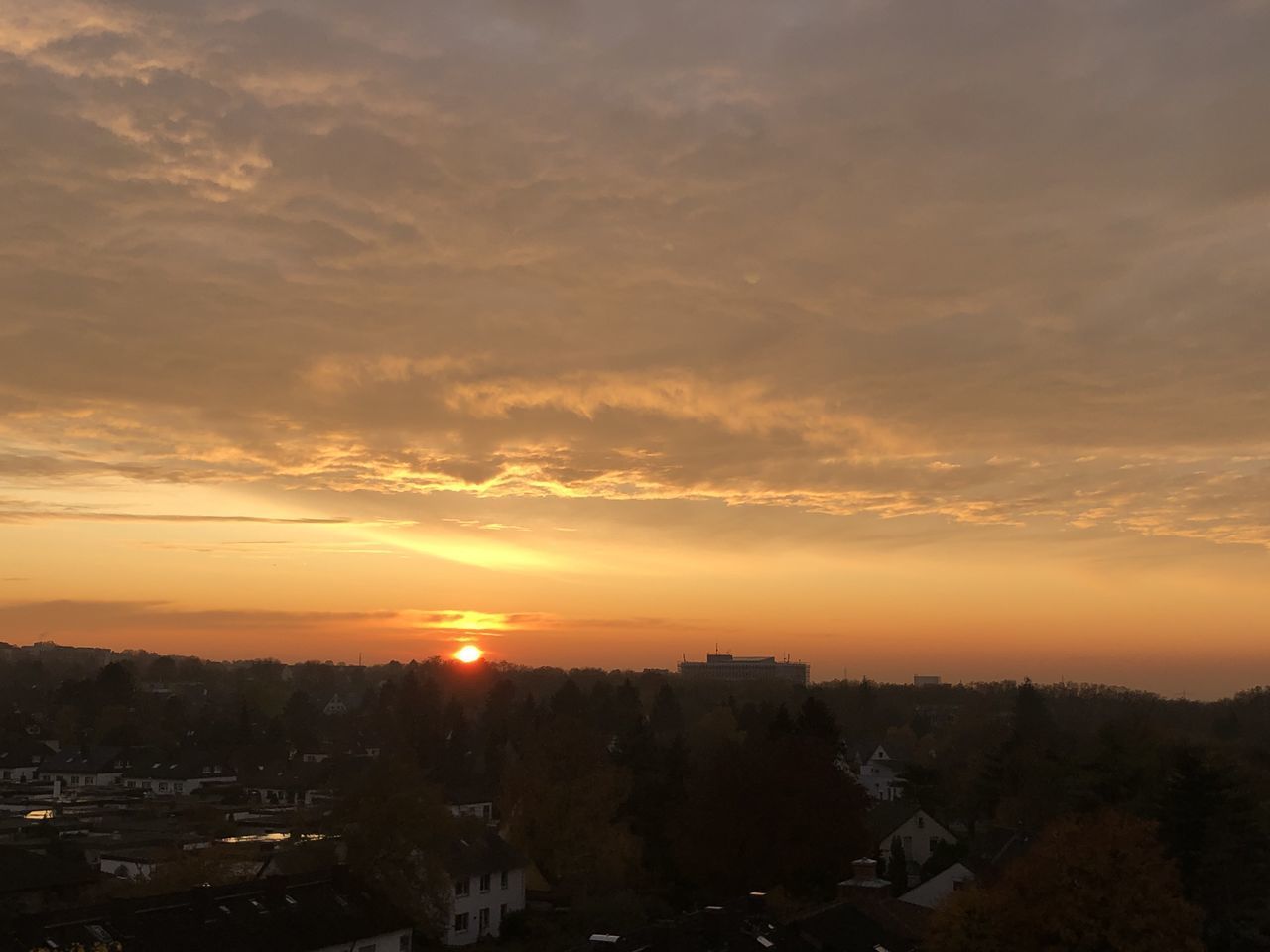 SILHOUETTE BUILDINGS IN CITY AGAINST SKY DURING SUNSET