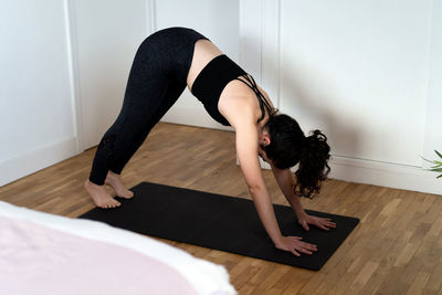 Low section of woman exercising on floor