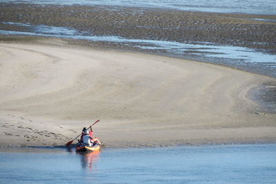 People kayak in sea