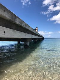 Bridge over sea against sky