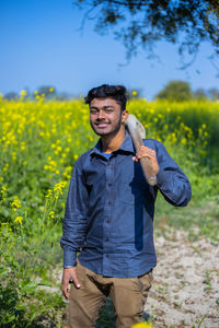 Portrait of smiling teenager standing in farm