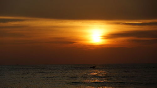 Scenic view of sea against orange sky