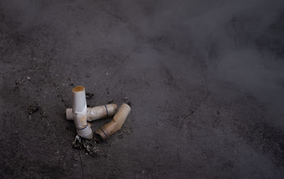 High angle view of cigarette butts on floor