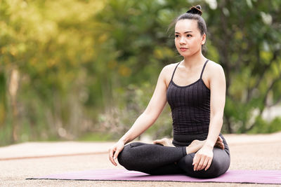 Young woman sitting outdoors