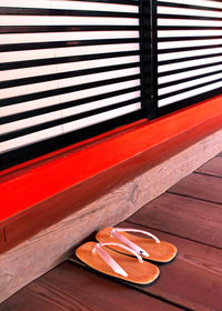 Slippers on hardwood floor by doors