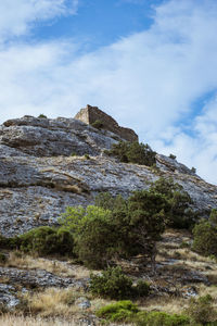 Low angle view of rock formation against sky