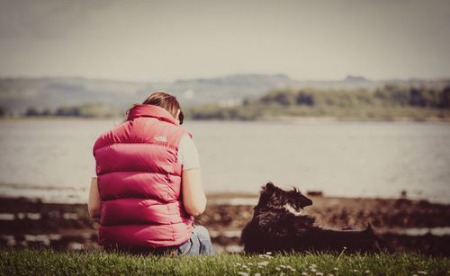 Woman sitting on grassy field