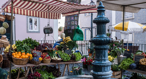 Vegetables and fruits by table at market for sale