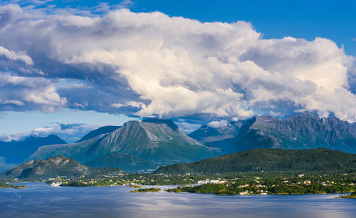 Scenic view of lake and mountains against sky