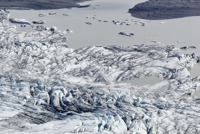 Close-up of frozen sea against mountain