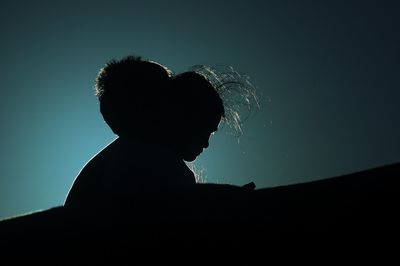 Low angle view of silhouette people against sky