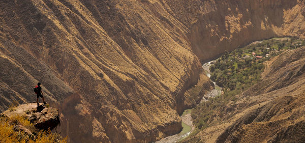 Mid distance view of man standing on cliff