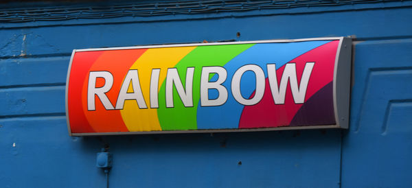 Close-up of arrow sign on wall