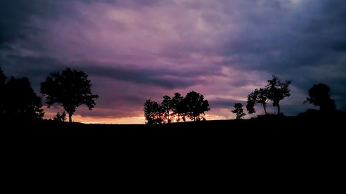 Silhouette trees against sky during sunset