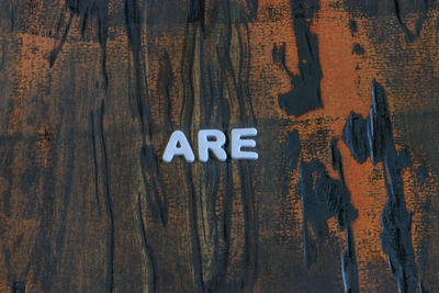 Close-up of text on wooden table