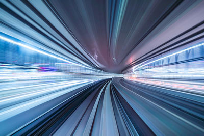 Long exposure image of illuminated road in city