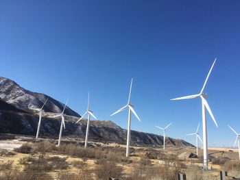 Wind turbines against clear blue sky