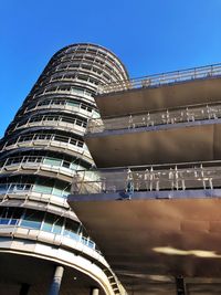 Low angle view of modern building against clear blue sky