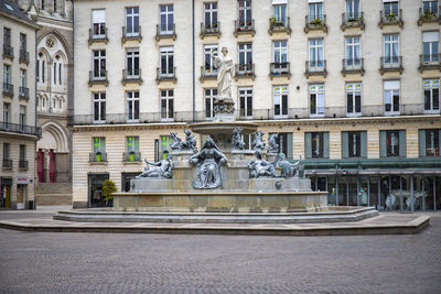 Statue on street in city