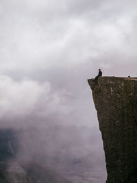 Low angle view of horse on mountain against sky