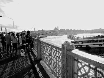 People in front of bridge