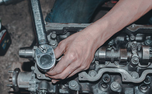 Midsection of man repairing car