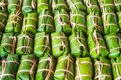 Full frame shot of food wrapped in banana leaves for sale at market stall