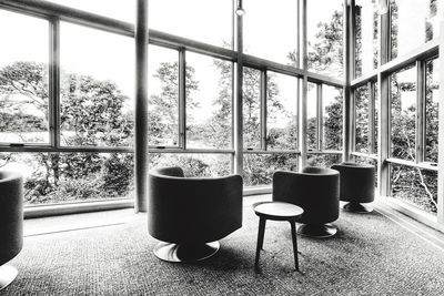 Table and potted plants on glass window