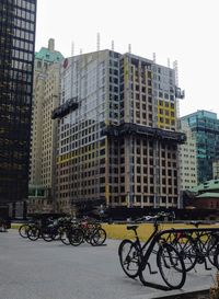 Bicycles on street against buildings in city