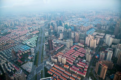 High angle view of modern buildings in city against sky