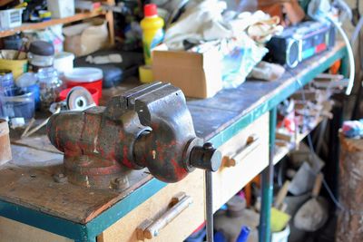 Close-up of old machine on table at workshop