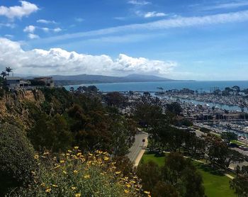High angle view of townscape by sea against sky