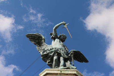 Low angle view of statue against blue sky