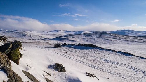 Scenic view of mountains against cloudy sky