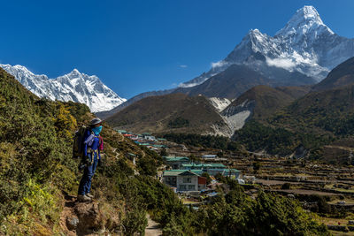 Scenic view of snowcapped mountains against blue sky