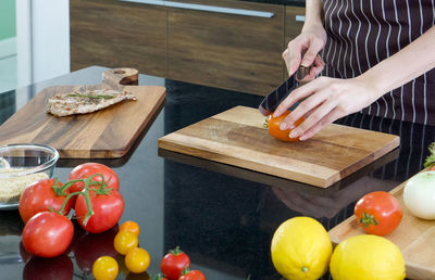 Cropped image of person preparing fruits on cutting board