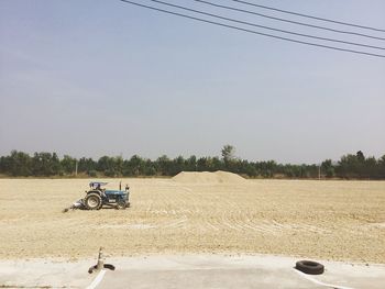 Tractor on agricultural field against sky