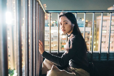 Portrait of woman sitting in window