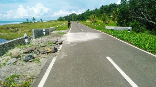 Empty road along countryside landscape