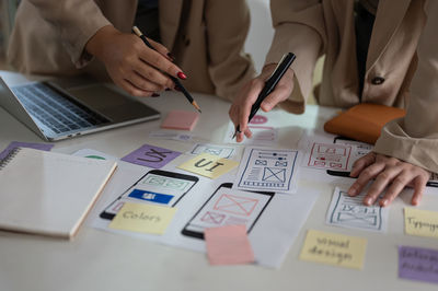 Midsection of business colleagues working on table